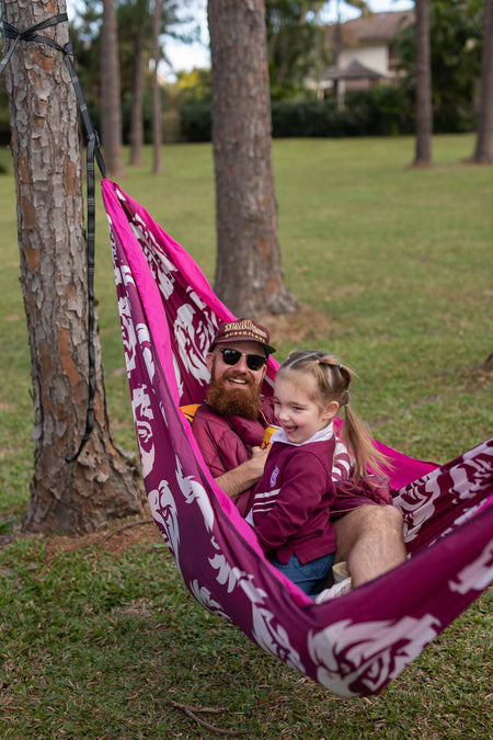 Man and child relaxing in Manly Sea Eagle NRL Nakie Recycled Hammock