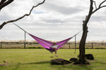 Purple Nakie hammock in a studio, emphasizing its recycled plastic bottle construction and portable design preview #9