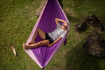 Woman lounging in a purple Nakie hammock, viewed from above, highlighting its eco-friendly and comfortable design preview #8