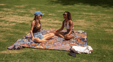 Two women on a Picnic Blanket in the park Nakie - Australia