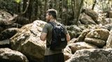 Man hiking in forest with sustainable Nakie backpack made from recycled plastic bottles, ideal eco-friendly hiking gear Nakie - Australia