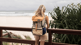 Man hiking in forest with sustainable Nakie backpack made from recycled plastic bottles, ideal eco-friendly hiking gear Nakie