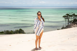 Woman in sand free towel standing on a beautiful beach Nakie - Australia