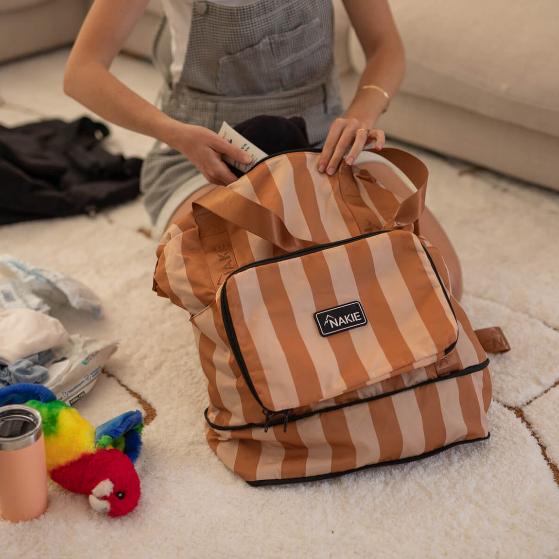 Sandy Trails tan and cream striped recycled tote bag with black trim, held open to show interior packing capacity