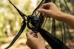 A person's hands attaching carabiners to Nakie's Bug Net, demonstrating the easy and secure setup process. preview #9