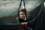 A woman enjoying her time in a Nakie hammock with a bug net, savoring the outdoor experience protected from insects. preview #17