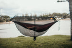 A woman relaxing inside Nakie's Bug Net while lying in a hammock, enjoying insect-free comfort during outdoor relaxation. preview #7