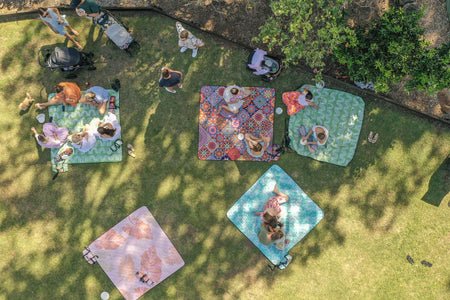 Drone aerial view of Nakie picnic blankets spread out, showcasing outdoor leisure and sustainability from above.