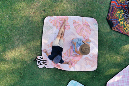 Drone aerial view capturing couples enjoying a picnic on Nakie blankets, epitomizing outdoor leisure and togetherness.