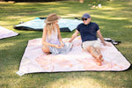 Friends enjoying a picnic on Nakie's eco-friendly blanket, epitomizing outdoor leisure and sustainability. preview #6